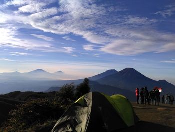 People on mountains against sky