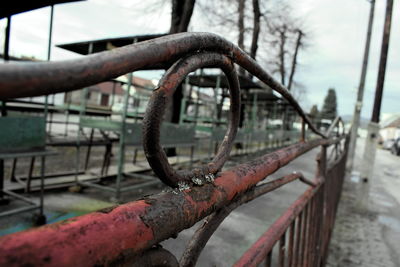 Close-up of metal fence against clear sky