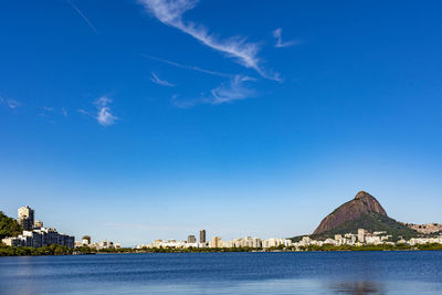 Scenic view of bay against blue sky