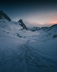 Scenic view of snowcapped mountains against sky during winter