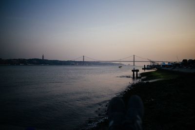 Low angle view of suspension bridge over river