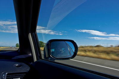 Close-up of side-view mirror of car