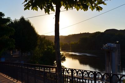 Scenic view of river against sky at sunset