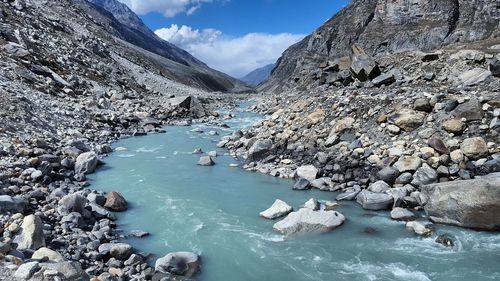 Scenic view of river amidst mountains against sky