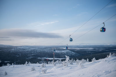 Scenic view of ski lift against sky