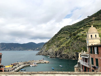 Panoramic view of boats in sea against buildings