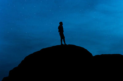 Silhouette man standing on mountain