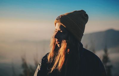 Close-up of woman wearing knit hat while standing outdoors