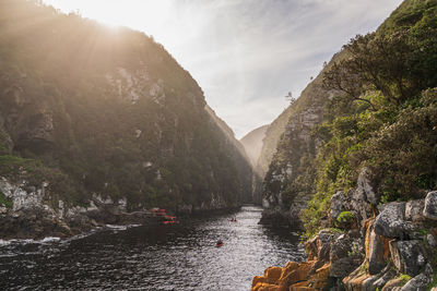 Scenic view of river amidst mountains against sky