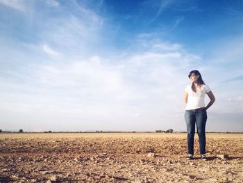 Silhouette of woman standing on field