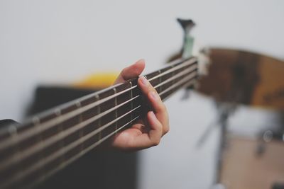 Cropped image of person playing guitar