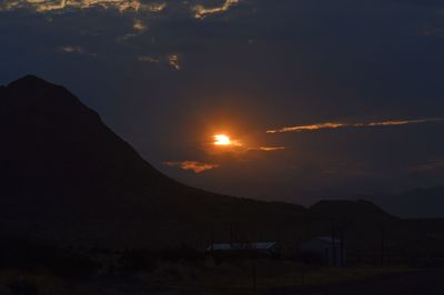 Scenic view of silhouette mountain against sky at sunset