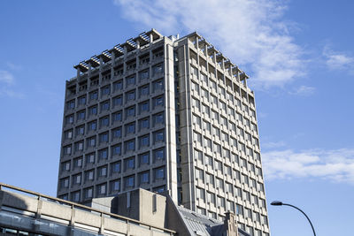 Low angle view of modern building against blue sky