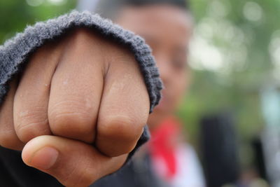 Close-up of person showing fist