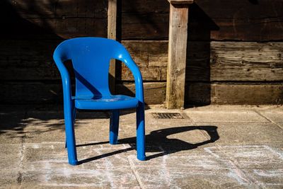 Empty chair against blue wall in building