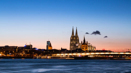 River rhein in cologne with illuminated buildings in background