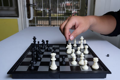 Low angle view of man playing on chess board