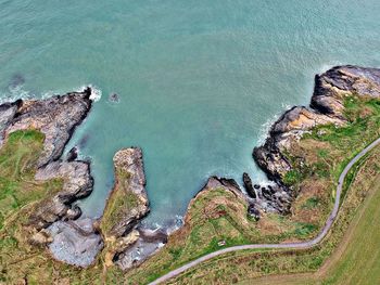 High angle view of cliff by sea