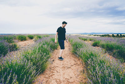 Full length of man standing on field against sky