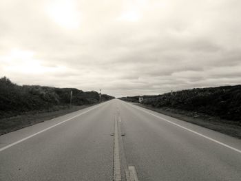 View of empty road against cloudy sky