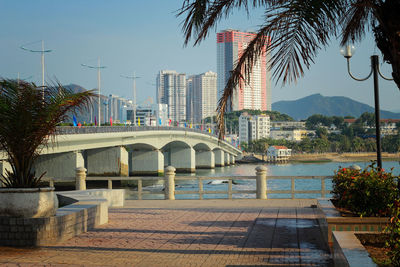 View of swimming pool in city against clear sky