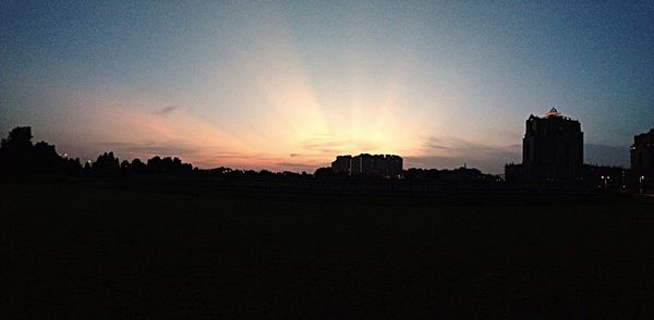 Silhouette built structures at sunset