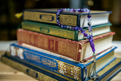 Stack of books with rosary beads