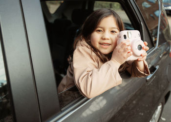 Portrait of young woman in car