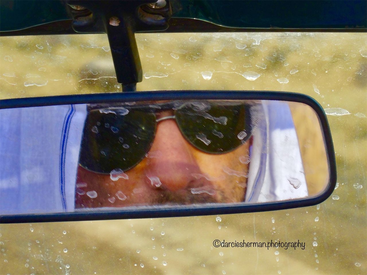 glass - material, car, real people, transportation, reflection, mode of transportation, one person, window, motor vehicle, land vehicle, lifestyles, transparent, men, day, portrait, close-up, leisure activity, headshot, outdoors, rain, human face, rainy season