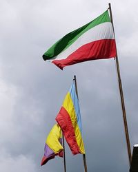 Low angle view of flags flag against sky