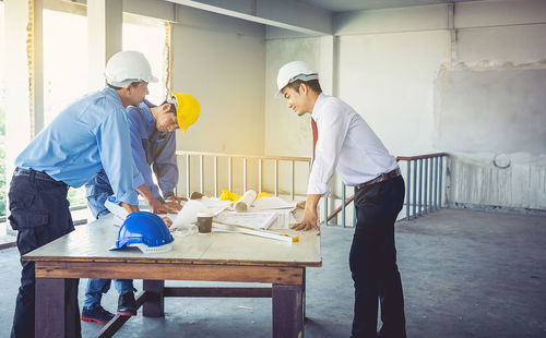 Architect working with colleague at construction site