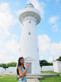 Woman standing against cloudy sky