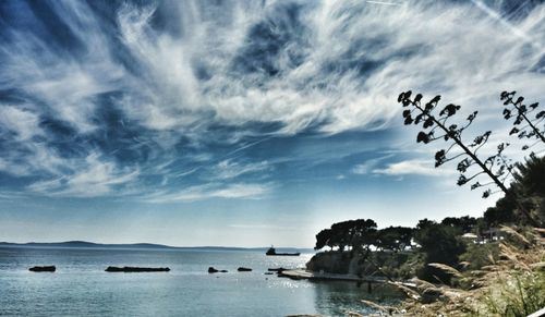 Scenic view of sea against cloudy sky