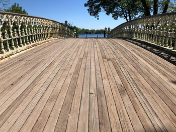 Surface level of footpath by railing against sky