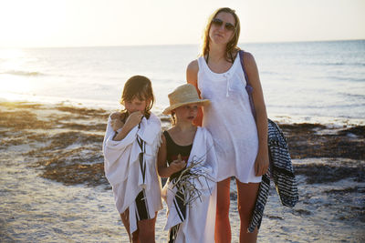 Portrait of mother with daughters by sea