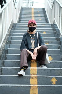 Woman sitting on staircase