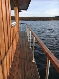 Railing by sea against sky