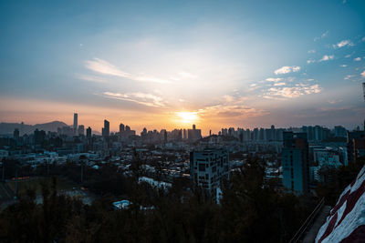 Cityscape against sky during sunset