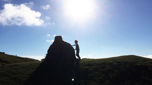 Silhouette of woman against sky