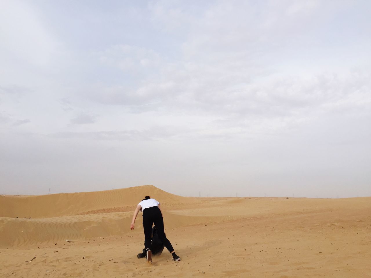 sand, landscape, sky, desert, arid climate, rear view, full length, tranquility, tranquil scene, lifestyles, men, leisure activity, walking, sand dune, scenics, nature, horizon over land, beauty in nature