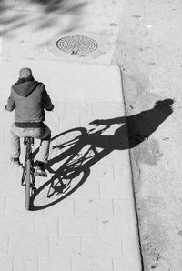 Rear view of man cycling on bicycle