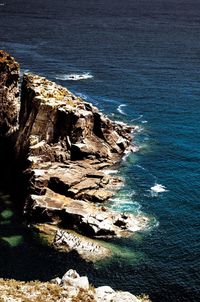 High angle view of rocks on sea shore