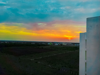 Scenic view of field against sky during sunset