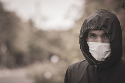 Portrait of man wearing mask and hood