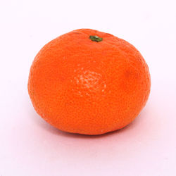 Close-up of orange apple against white background