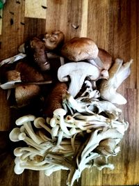 High angle view of mushrooms on wooden table