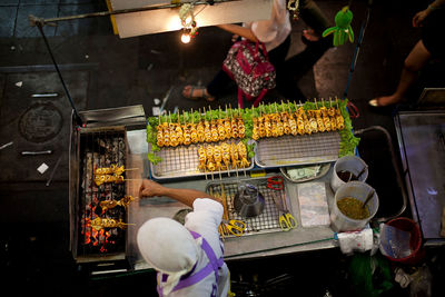 High angle view of man cooking squid at market stall
