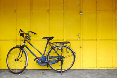 Bicycle parked against wall