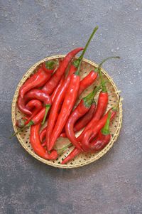 High angle view of red chili peppers in bowl on table