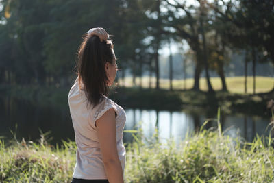 Woman standing against lake